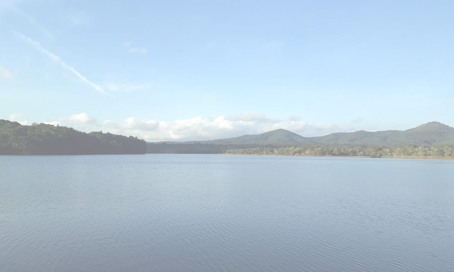 A lake with hills in the distance